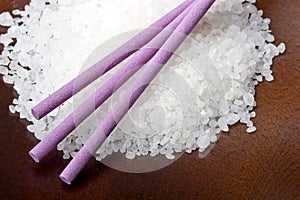 Sea bath salt with lavender sticks wood background