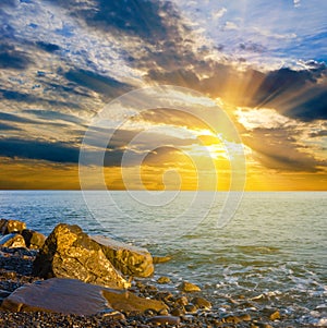 Sea bay with huge rocks near a coast at the sunset