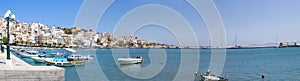 Sea bay with moored boats. Promenade in Mediterranean town Sitia, Crete