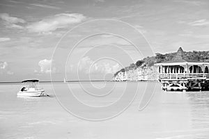 Sea beach with boat and shelter in st johns, antigua