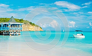 Sea beach with boat and shelter in st johns, antigua photo