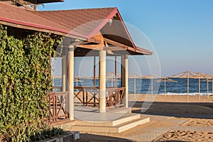 Sea beach and a cafe pavilion in the open air.