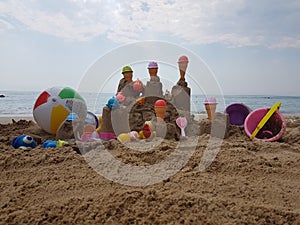 Sea beach castle of sand made by children with toys on it by t