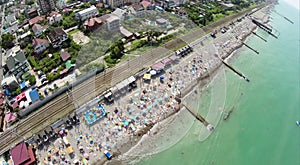 Sea beach full of people in coastal town with