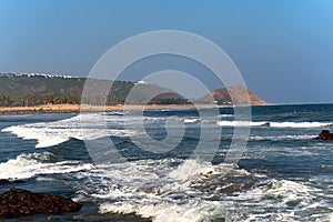 Sea beach with mountain and water waves