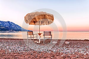 Sea beach at sunrise, Beach umbrella and chaise lounges