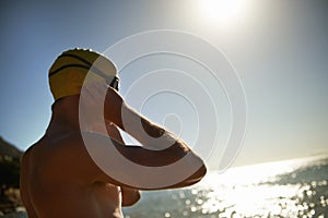 Sea, beach sunset and man for swimmer exercise, workout or outdoor training in ocean, nature or water. Mockup space