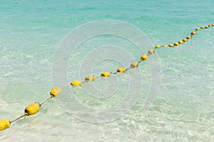 Sea beach with yellow buoys.