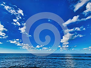 Sea and blue-sky. Calm sea. Sea surface summer wave background. Tropical paradise. Shore water blue sea and blue sky and white