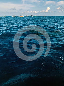 Sea and blue sky with clouds with small boats