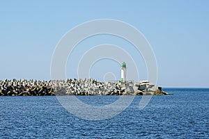 Sea breakwater made from large concrete tetrapods and cubes at Baltic Sea, Ventspils, Latvia