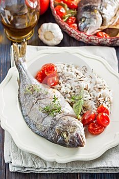 Sea bream/Dorado baked with tomato confit and rice