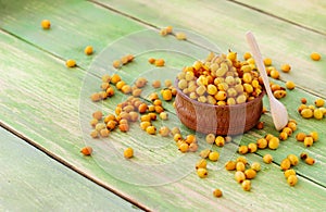 Sea buckthorn berries on a green wooden background