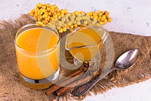 Sea buckthorn juice with honey and cinnamon. Vitamin autumn drink.