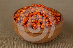 Sea buckthorn, orange berries in wooden bowl photo