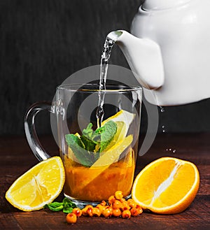 Sea buckthorn tea made from fresh berries and slices of lemon and apalsin.