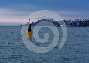 Sea buoy at the entrance to the seaport of Odessa in the evening
