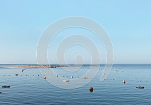 Sea buoys and lifebuoys on the sea water on the background of blue sky