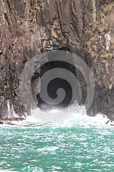 Sea Cave in rocks with a blast of water off the Coast of Bruny Island Tasmania Australia