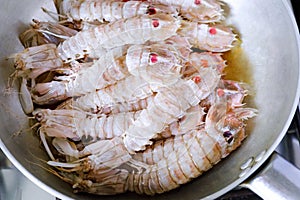 Sea cicadas, cooking in a pan.