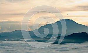 Sea of clouds at the foot of a mountain.