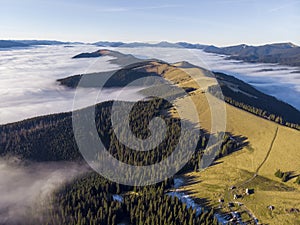 Sea of clouds and Picturesque Mountains Above. Beautiful Carpathians at early winter or Autumn Aerial View