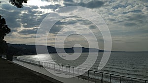 Sea coast on a calm day and cloudy sky