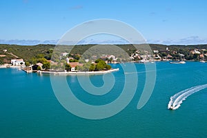 Sea coast of Mahon, Spain. Boats in sea harbor. Naval storehouse and careening wharf. Summer vacation on mediterranean photo