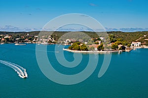 Sea coast of Mahon, Spain. Boats in sea harbor. Naval storehouse and careening wharf. Summer vacation on mediterranean