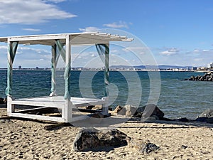 Sea coast in the resort town of sunny Bulgaria, a gazebo for relaxing on the seashore.