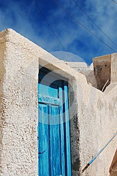 Sea color wooden door at Santorini, Greece