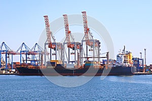 Sea container ship loading at the container terminal in the Odessa seaport. Ships, transport in sea port. Odesa, Ukraine photo