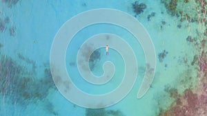 Sea, coral reef and woman snorkeling from drone with water, freedom and tropical island holiday. Diving, adventure and