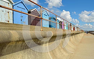 Sea defenses railings and beach huts.