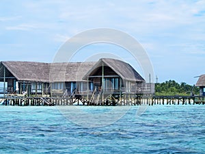 Sea facing cottages on maldive island photo