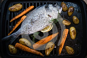 Sea fish with carrot and sweet potato on the grill