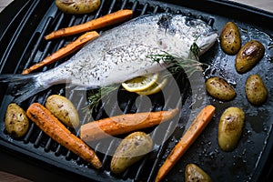 Sea fish with carrot and sweet potato on the grill