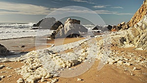 Sea Foam (aka Beach Foam, Ocean Foam or Spume) on a Sandy Beach on the Atlantic Coast of Portugal at