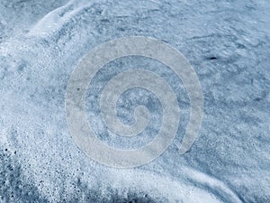 Sea foam on beach sand with clear water Travel and tourism, bubbles and macro waves.