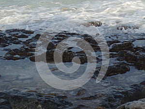 Sea foam Caribbean sea with rocks