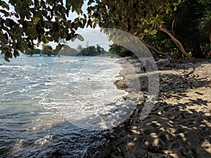 Sea foam covered white sand beach  of laxaman pur beach  of andaman nikobar iland