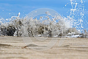 Sea foam created by waves surging on sand and creating amazing texture and patterns.