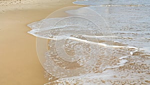 Sea foam on the sandy beach at Bat Yam, Israel