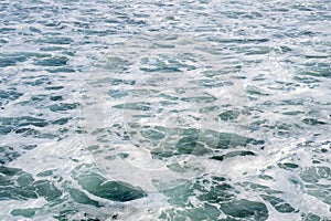 Sea foam and waves of the Pacific Ocean on the California Coast. Abstract, useful for backgrounds