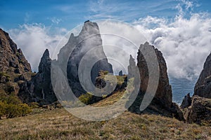 Sea fog is moving on the rocks of the volcanic mountain range