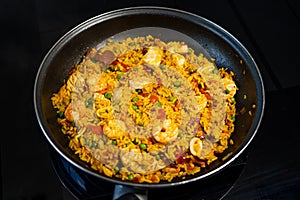 Sea Food Home made Paella Valenciana. Typical Spanish seafood paella in traditional pan. Close-up. Selective focus