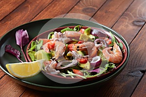 Sea food salad with shrimps, avocado, cherry tomatoes, red hot chilly pepper, red onion, arugula, beet leaves,rukola.balsamic sauc