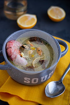 Sea food soup, Spicy Soup with Shrimps and mussels in a gray bowl on dark background