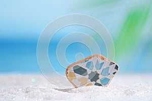 Sea glass seaglass on glitter sand with ocean
