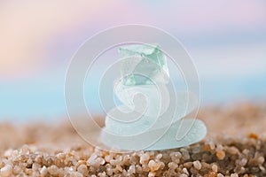 Sea glass tower on beach sand